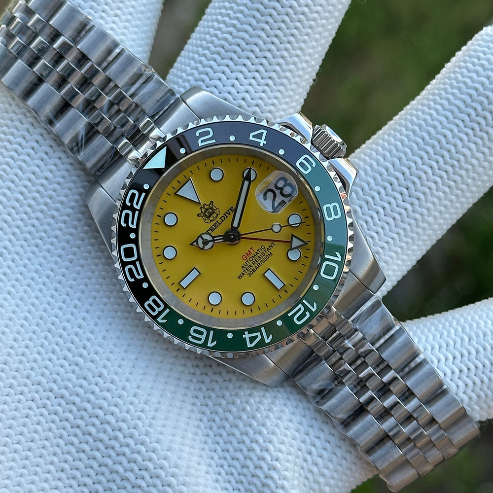Steeldive SD1993 GMT watch with yellow dial and green ceramic bezel, steel jubilee bracelet, front view