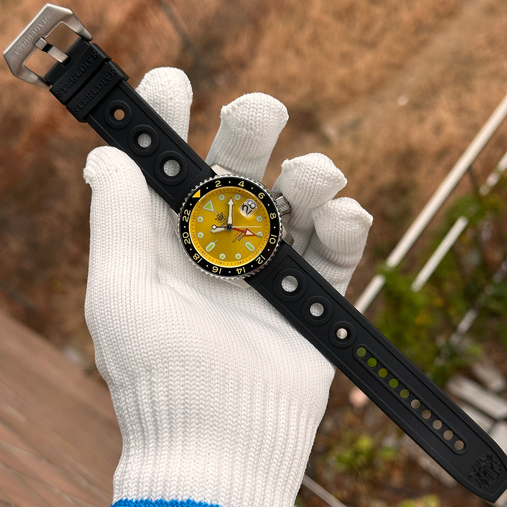 Steeldive SD1994 watch with yellow dial on full length black rubber dive strap, flat lay