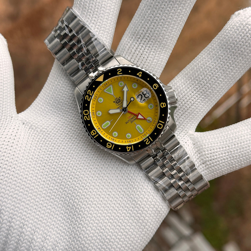 Steeldive SD1994 yellow dial GMT on jubilee bracelet held on a gloved hand outdoors