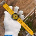 Steeldive SD1994 watch laid on yellow rubber dive strap, full length flat lay view