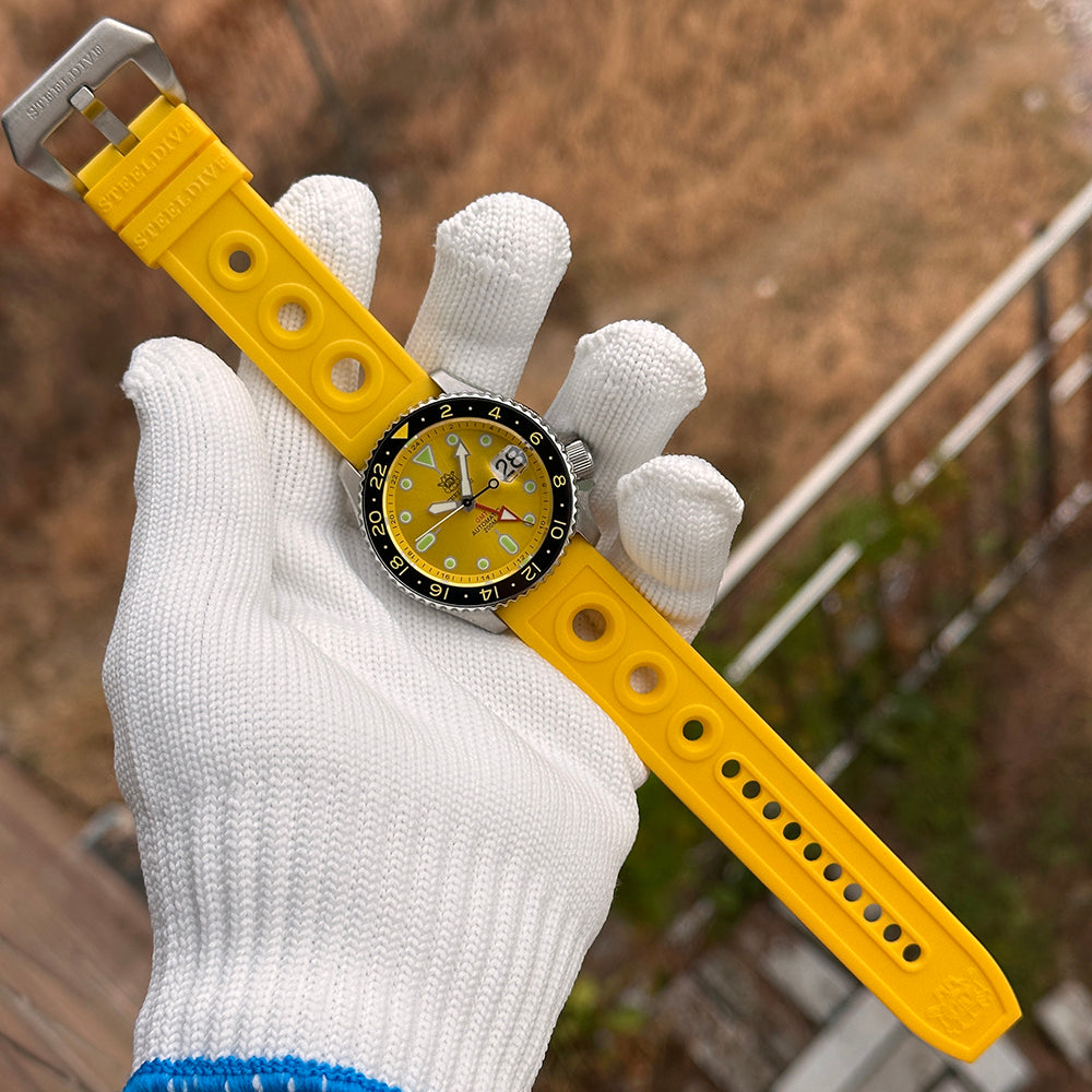 Steeldive SD1994 watch laid on yellow rubber dive strap, full length flat lay view