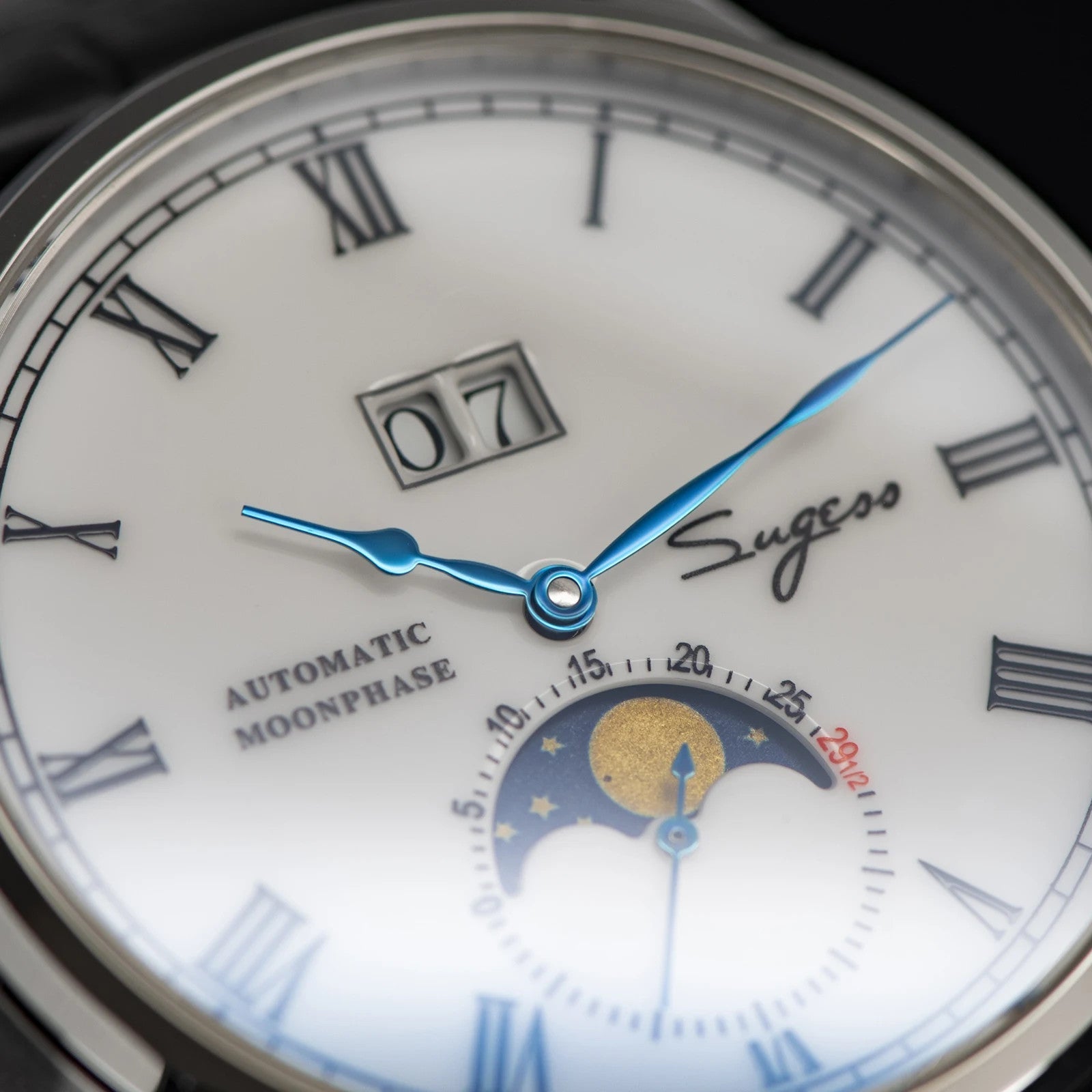Sugess 2528M-1 moonphase watch dial close-up with white face, blue hands, big date and moonphase