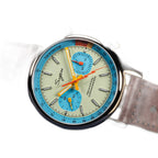 Sugess 387F teal-blue panda chronograph on brown leather strap, angled view with reflection