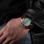 Sugess 387F teal-blue panda chronograph worn on wrist with brown racing leather strap, close-up