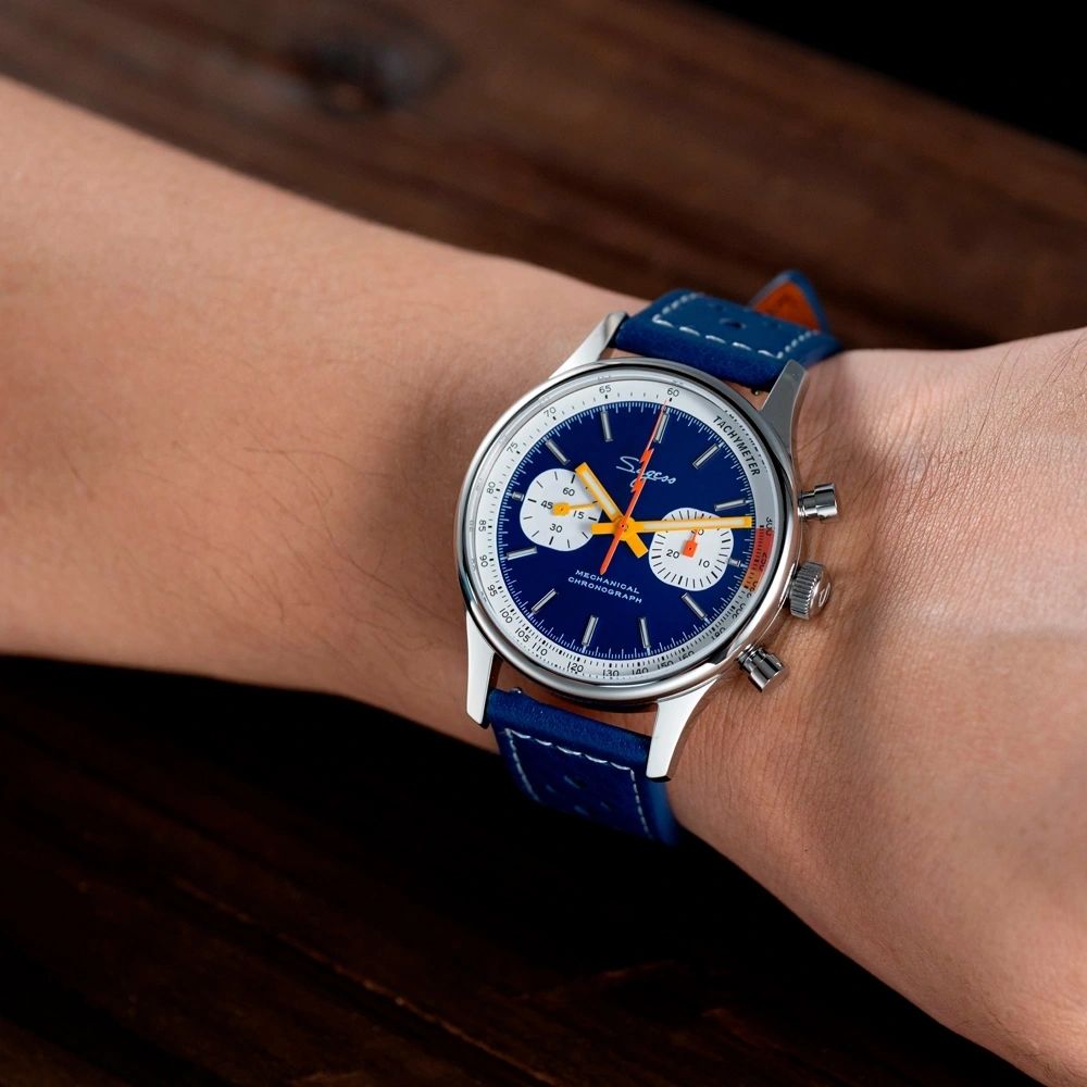 Sugess S387 dark blue chronograph worn on wrist with blue racing leather strap, close-up