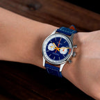 Sugess S387 dark blue chronograph worn on wrist with blue racing leather strap, close-up