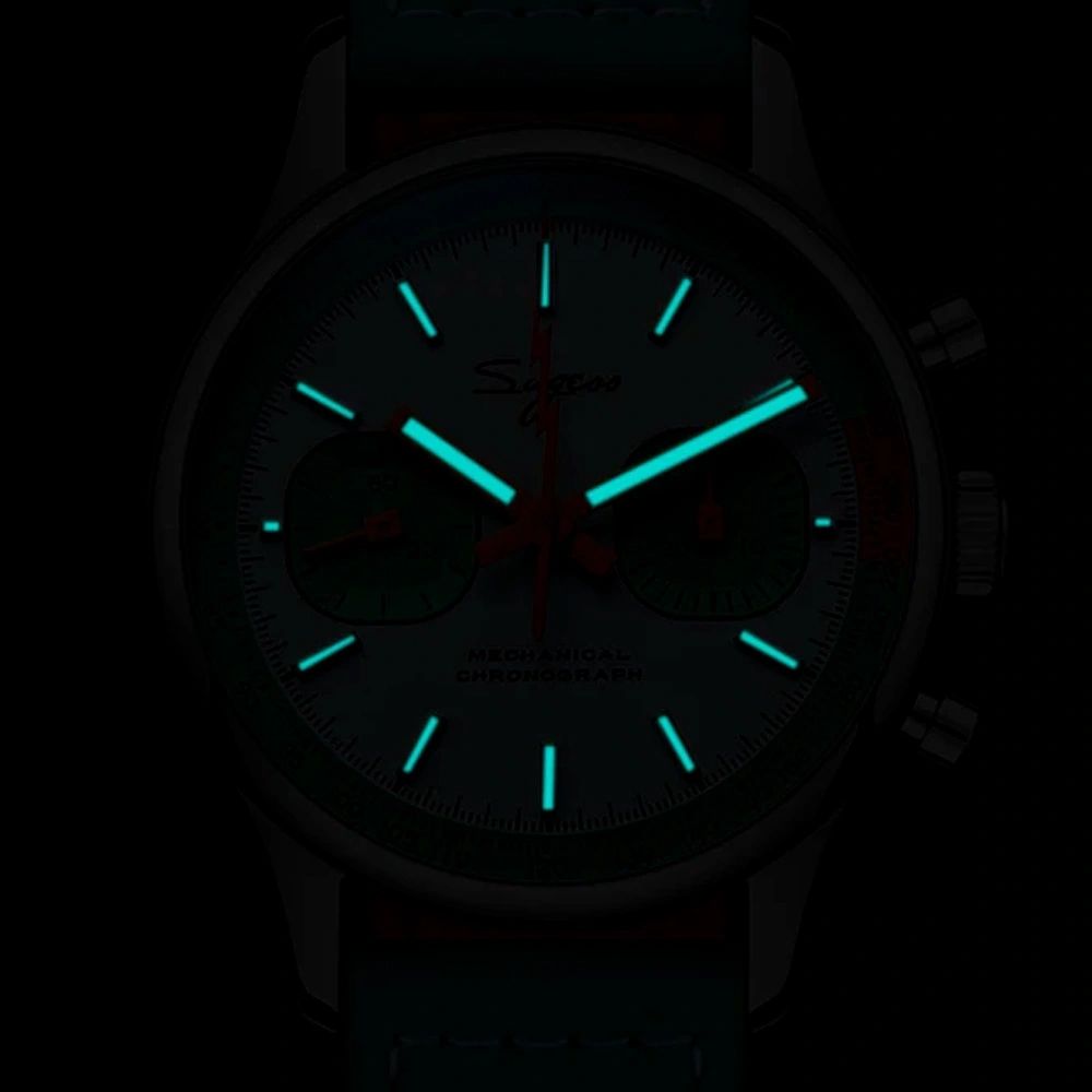 Sugess S387 chronograph dial glowing blue-green lume in the dark, hour markers and hands, close-up