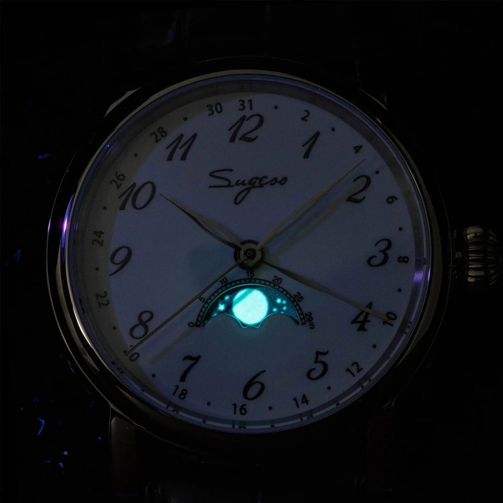Sugess S395-02 white moonphase dial glowing lume in the dark with blue moon phase display, close-up