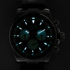 Sugess S418-2 black panda chronograph dial and markers glowing blue-green lume in the dark, close-up