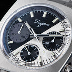 Sugess S419 dual color split black and silver dial on steel bracelet, angled on blue book