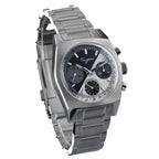 Sugess S419 dual color split black and silver dial on steel bracelet, angled product view on blue