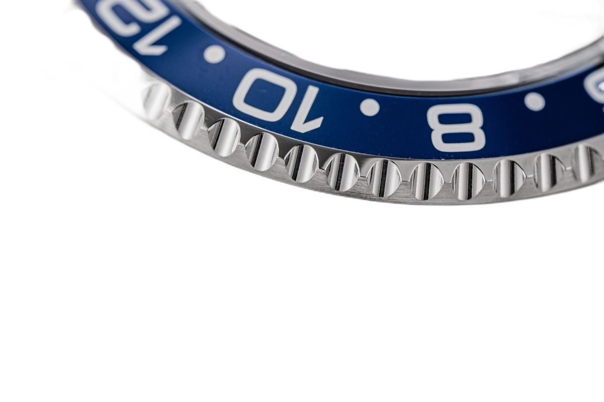 Sugess S420-2 Batman GMT diver macro, blue coin-edge bezel, polished lug and jubilee bracelet, close-up