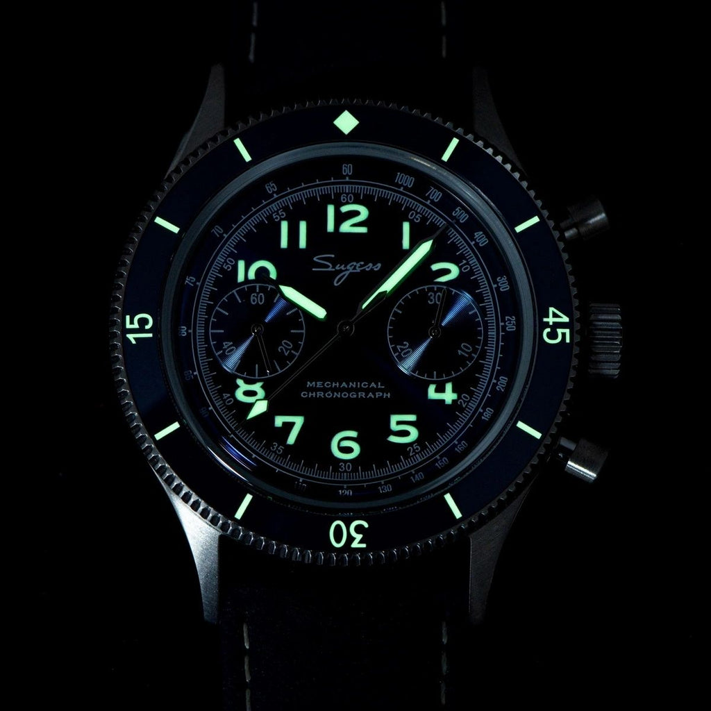 Sugess S423 chronograph dial glowing green lume in the dark, applied numerals and hands, close-up
