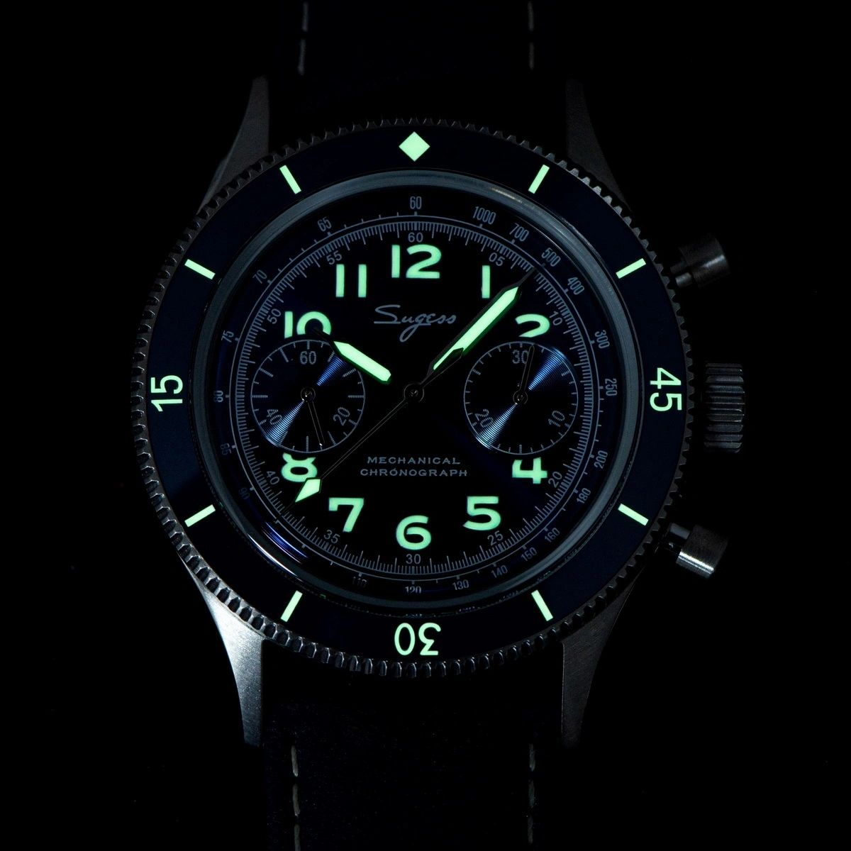 Sugess S423 chronograph dial glowing green lume in the dark, applied numerals and hands, close-up