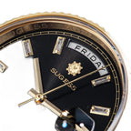 Sugess S433 gold day-date, black dial, baguette markers, gold president bracelet, angled view with crown
