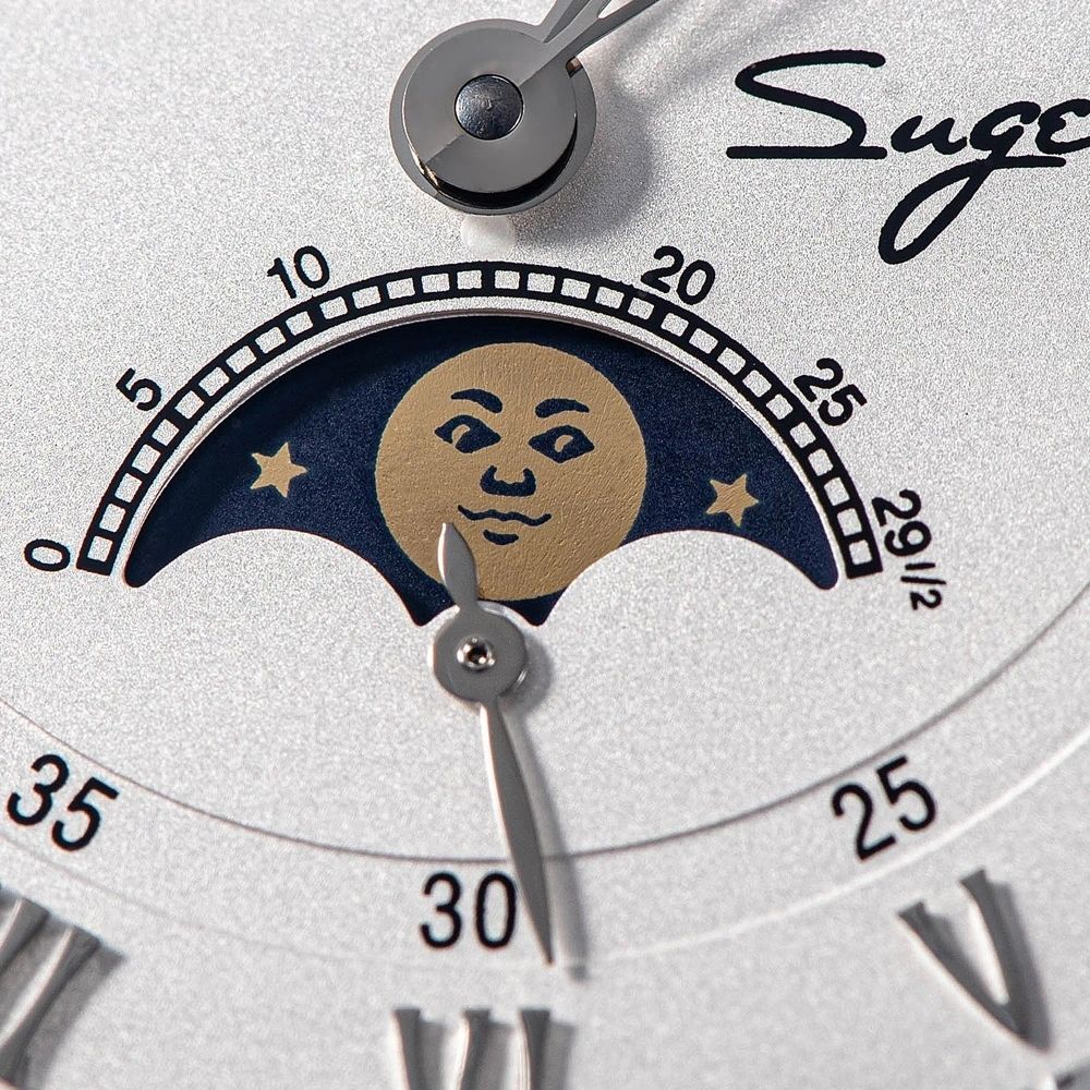 Sugess S437-05 dial moon phase display macro, gold moon face with stars on blue, retrograde date scale, close-up