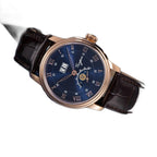 Sugess S437 blue dial moonphase, rose gold case, brown leather strap, angled view on a blue book