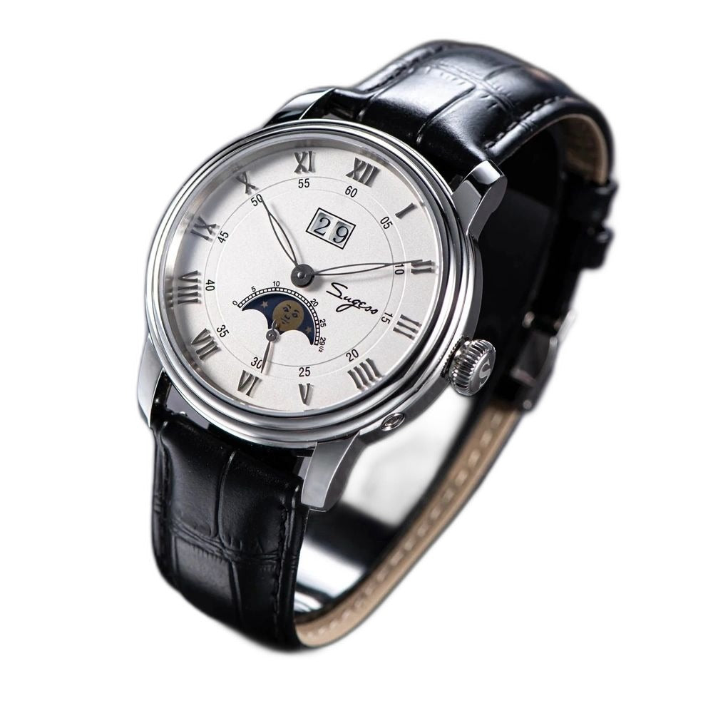 Sugess S437 silver dial moonphase, steel case, black leather strap, angled view beside a blue book