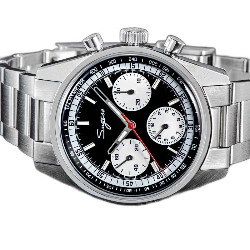 Sugess S442 black panda chronograph, white sub-dials, steel bracelet, three-quarter angled view on dark surface