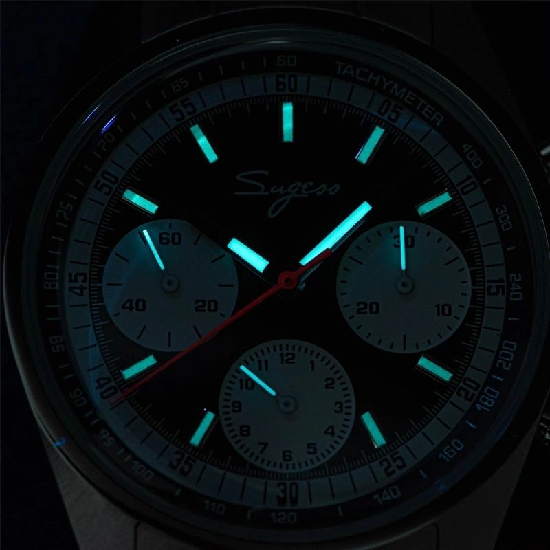 Sugess S442 black dial chronograph glowing blue-green lume in the dark, markers and hands, sub-dials, close-up
