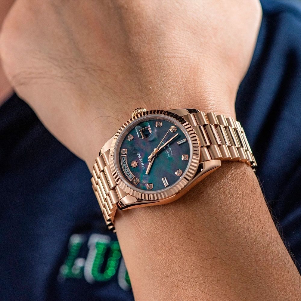 Sugess S449 black mother-of-pearl day-date on the wrist, rose gold president bracelet, worn with a navy shirt