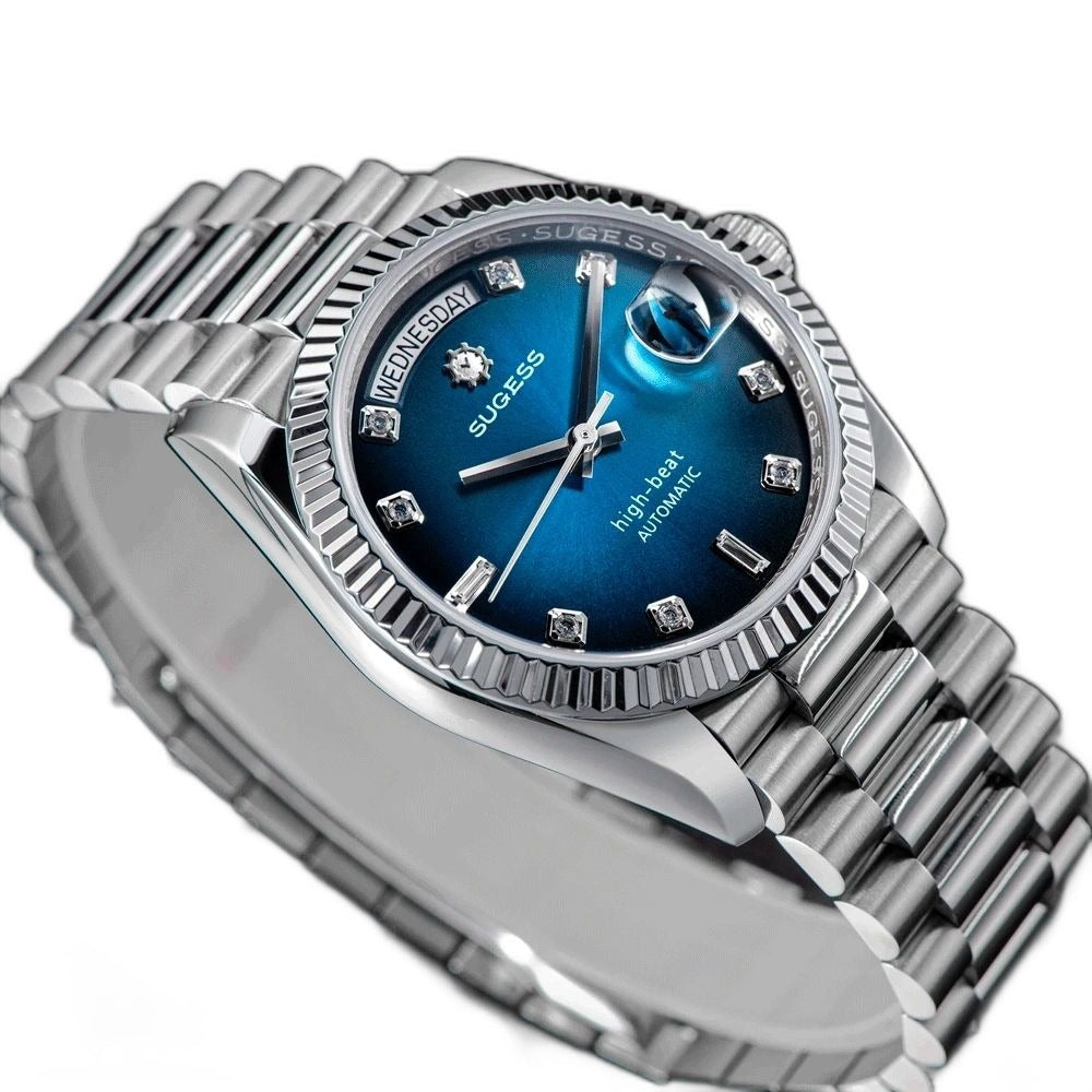 Sugess S449 blue dial day-date, fluted steel bezel, diamond markers, three-quarter angled view on dark surface