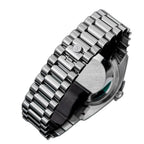 Sugess S449 steel president bracelet with S-engraved clasp and screw-down caseback, angled close-up on black