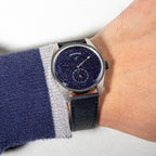 Sugess S451 blue sandstone aventurine dress watch on the wrist, blue strap, worn with a navy jumper