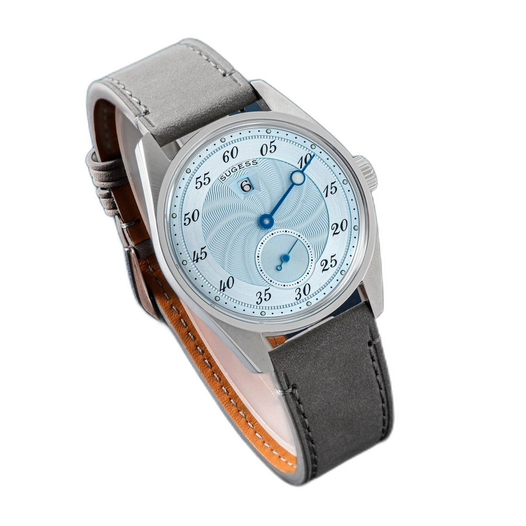 Sugess S451 ice blue guilloche regulator dress watch, grey suede strap, angled view on navy leather