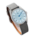 Sugess S451 ice blue guilloche regulator dress watch, grey suede strap, angled view on navy leather