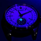 Sugess S452 moonphase dress watch dial glowing blue lume in the dark, moon disc and hands aglow, close-up