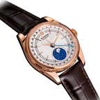 Sugess S452 rose gold moonphase watch, white dial, brown leather strap, angled view with crown to the right, on black