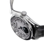 Sugess S452 steel moonphase watch side profile close-up, fluted bezel and crown, white dial, black strap, on black