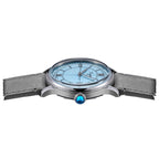 Sugess S455 Art Master ice blue dial dress watch side profile, blue gem crown, grey suede strap, on black