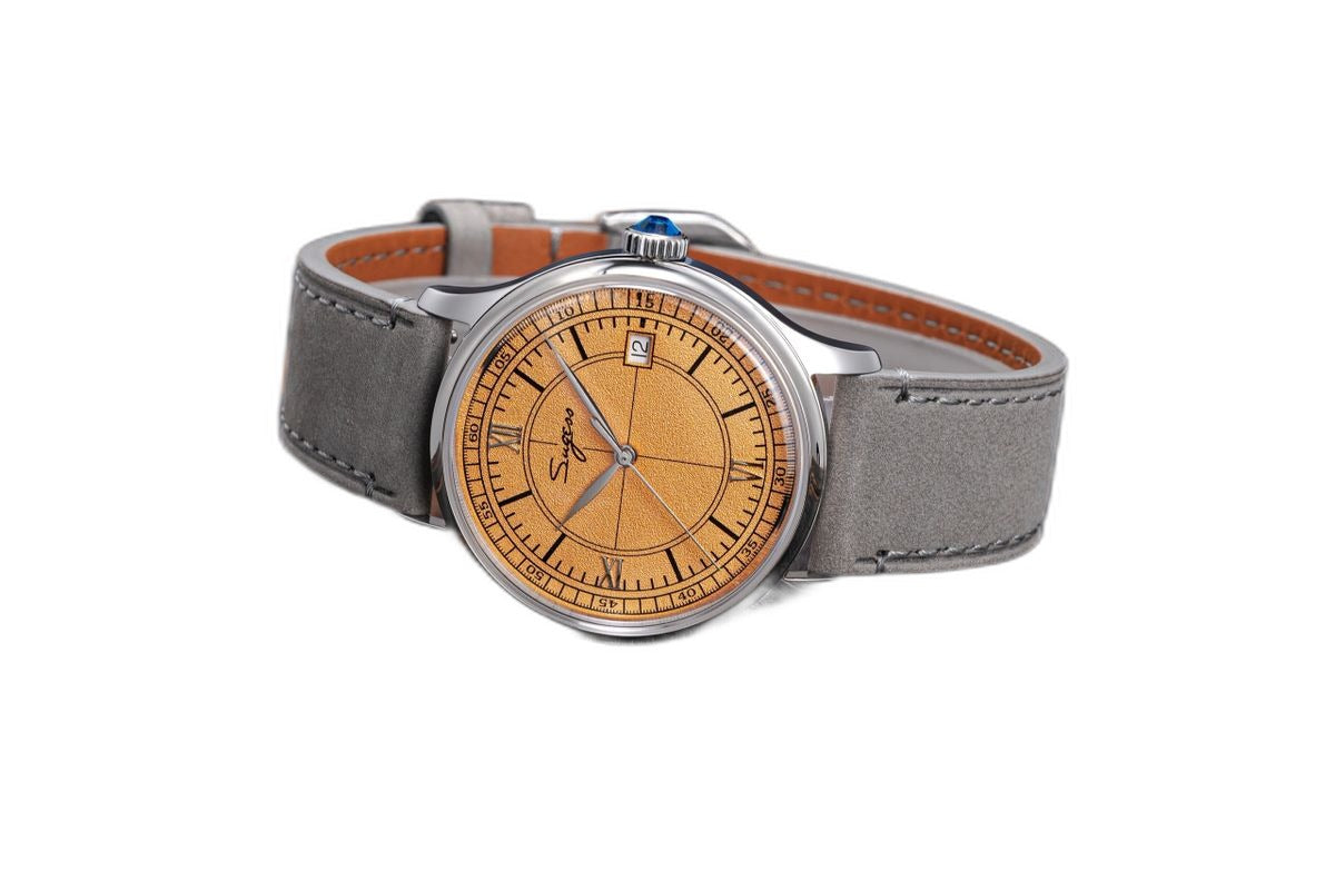 Sugess S455 Art Master salmon frosted dial dress watch, grey suede strap, angled view on dark wood