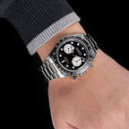 Sugess S457 black dial manual chronograph worn on the wrist with a navy jumper, white sub-dials