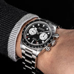 Sugess S457 black dial manual chronograph worn on the wrist with a grey jumper, white sub-dials