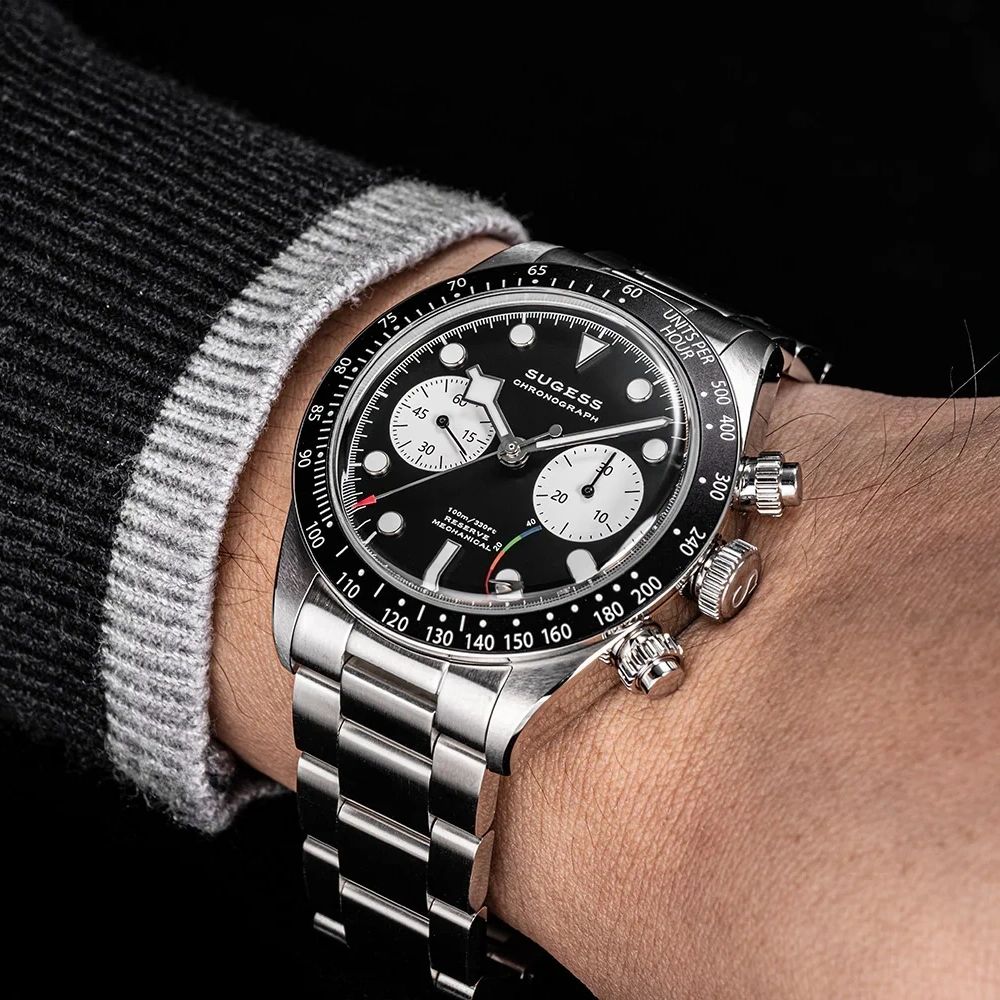 Sugess S457 black dial manual chronograph worn on the wrist with a grey jumper, white sub-dials