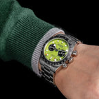 Sugess S457 lime green dial manual chronograph worn on the wrist with a green jumper