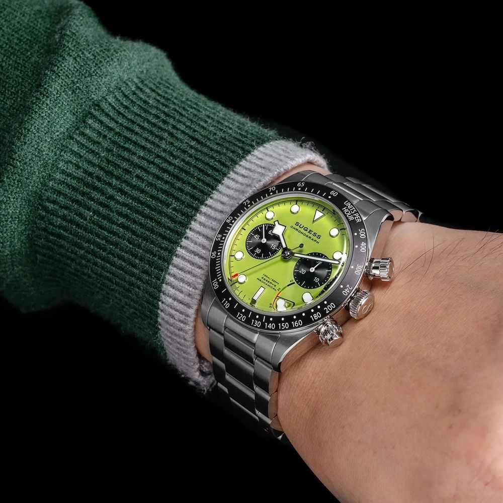 Sugess S457 lime green dial manual chronograph worn on the wrist with a green jumper