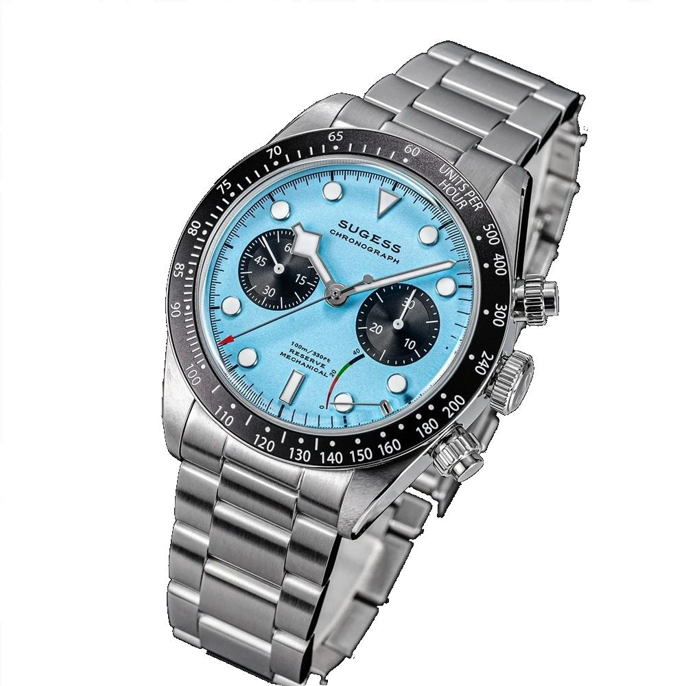 Sugess S457 teal blue dial manual chronograph, black sub-dials, steel bracelet, angled view on black