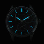 Sugess S458 blue dial power-reserve watch, navy leather strap, three-quarter angled view on black