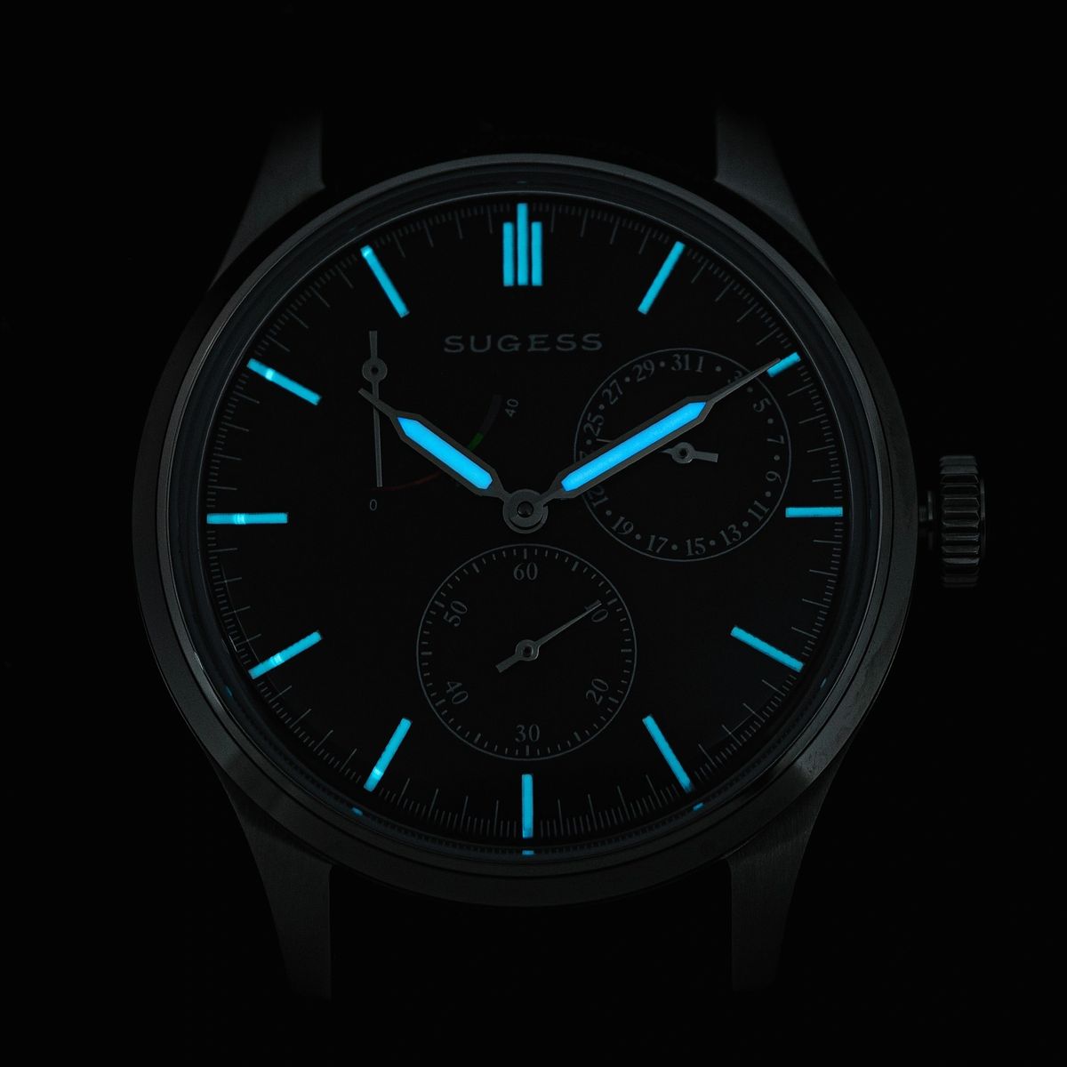 Sugess S458 blue dial power-reserve watch, navy leather strap, three-quarter angled view on black