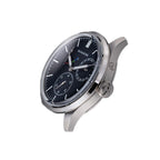 Sugess S458 blue dial glowing blue lume in the dark, markers and hands aglow, navy leather strap, close-up