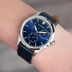 Sugess S458 blue dial power-reserve watch worn on the wrist with a navy leather strap