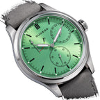 Sugess S458 green dial power-reserve watch, grey suede strap, angled view with date sub-dial to the right, on black