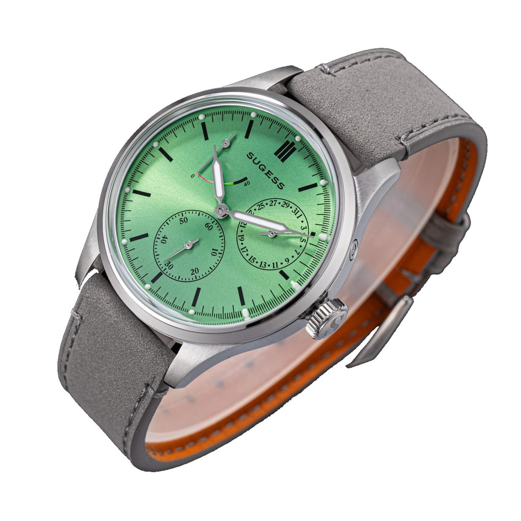 Sugess S458 green dial power-reserve watch, grey suede strap, crown-left angled view on black