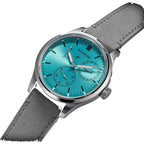 Sugess S458 petrol teal dial power-reserve watch, grey suede strap, front three-quarter view on black