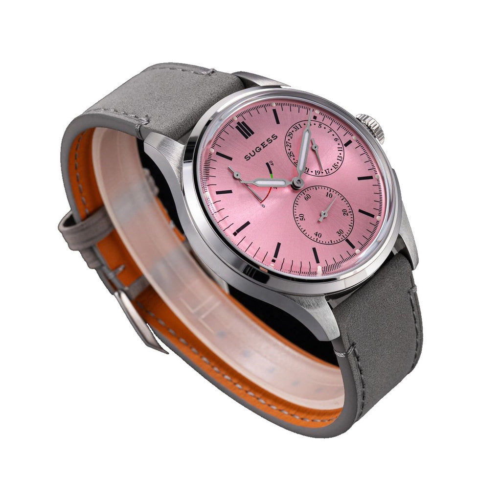 Sugess S458 pink dial power-reserve watch, grey suede strap, low three-quarter angle on black