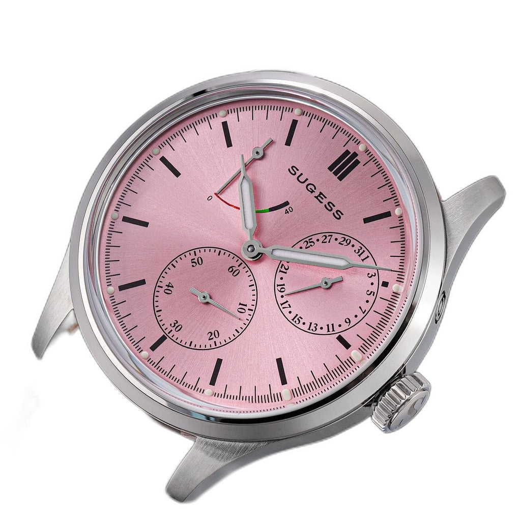 Sugess S458 pink dial power-reserve watch, grey suede strap, front three-quarter tilt on black